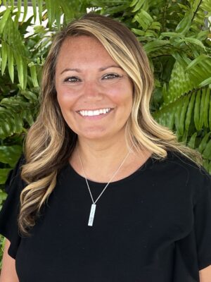 A woman wearing black and smiling